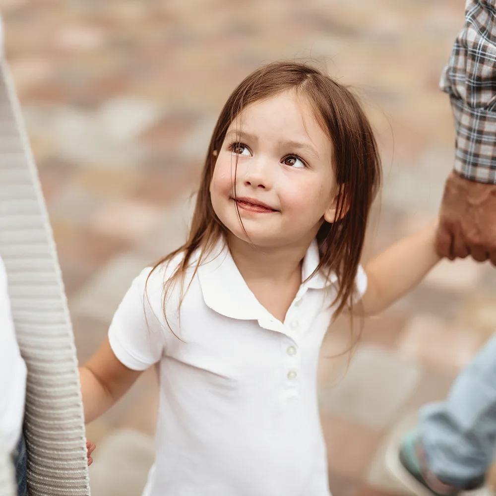 Child smiling up at mom at a Bright Beginnings Academy daycare.