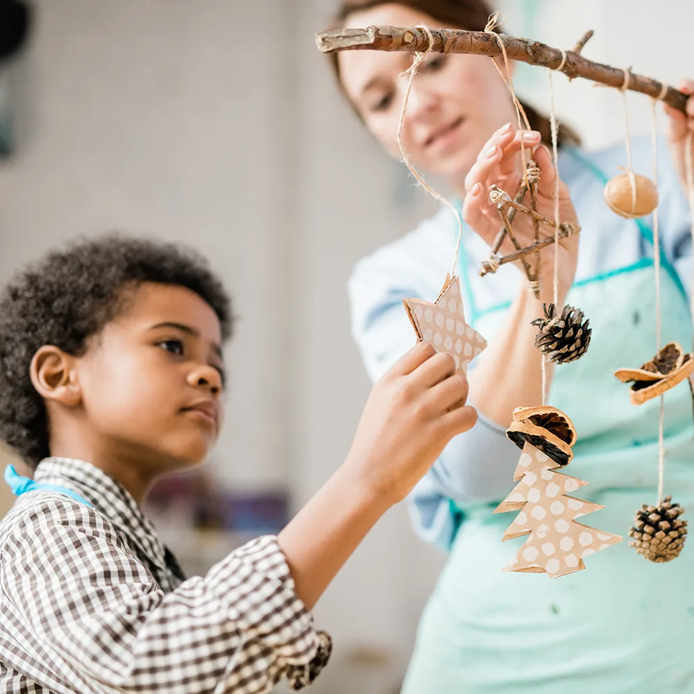 A child looking at stars hanging on string from a branch in a Bright Beginnings Academy daycare