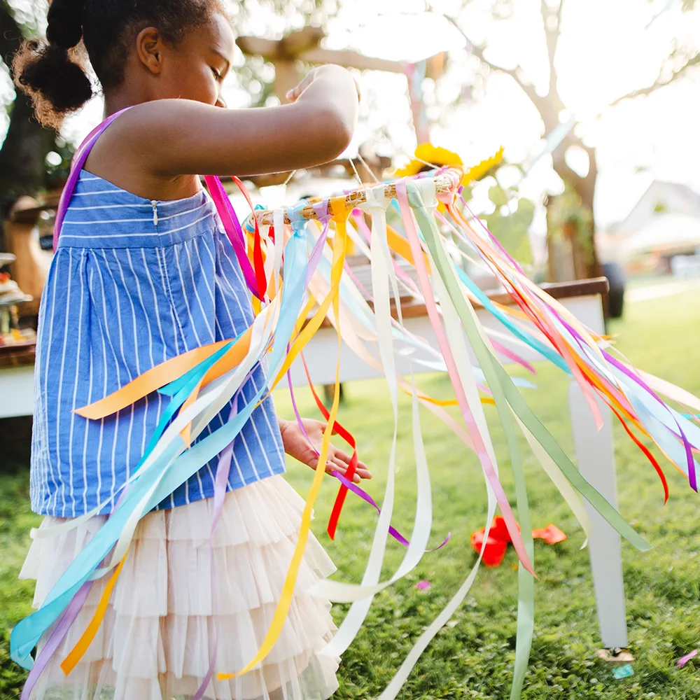 A child working on a colorful summer craft outside of a Bright Beginnings Academy daycare