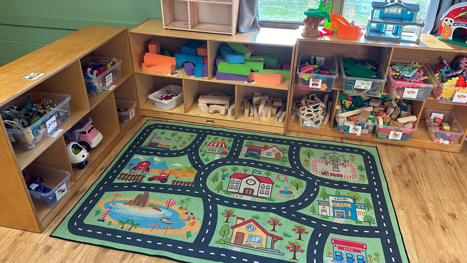 A game board on the ground and a kids play area at Little Sprouts in Burnsville