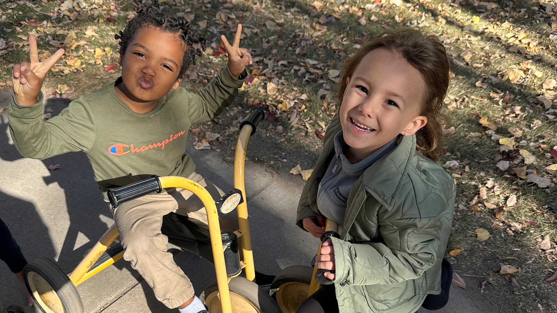 Two kids playing outside on bikes
