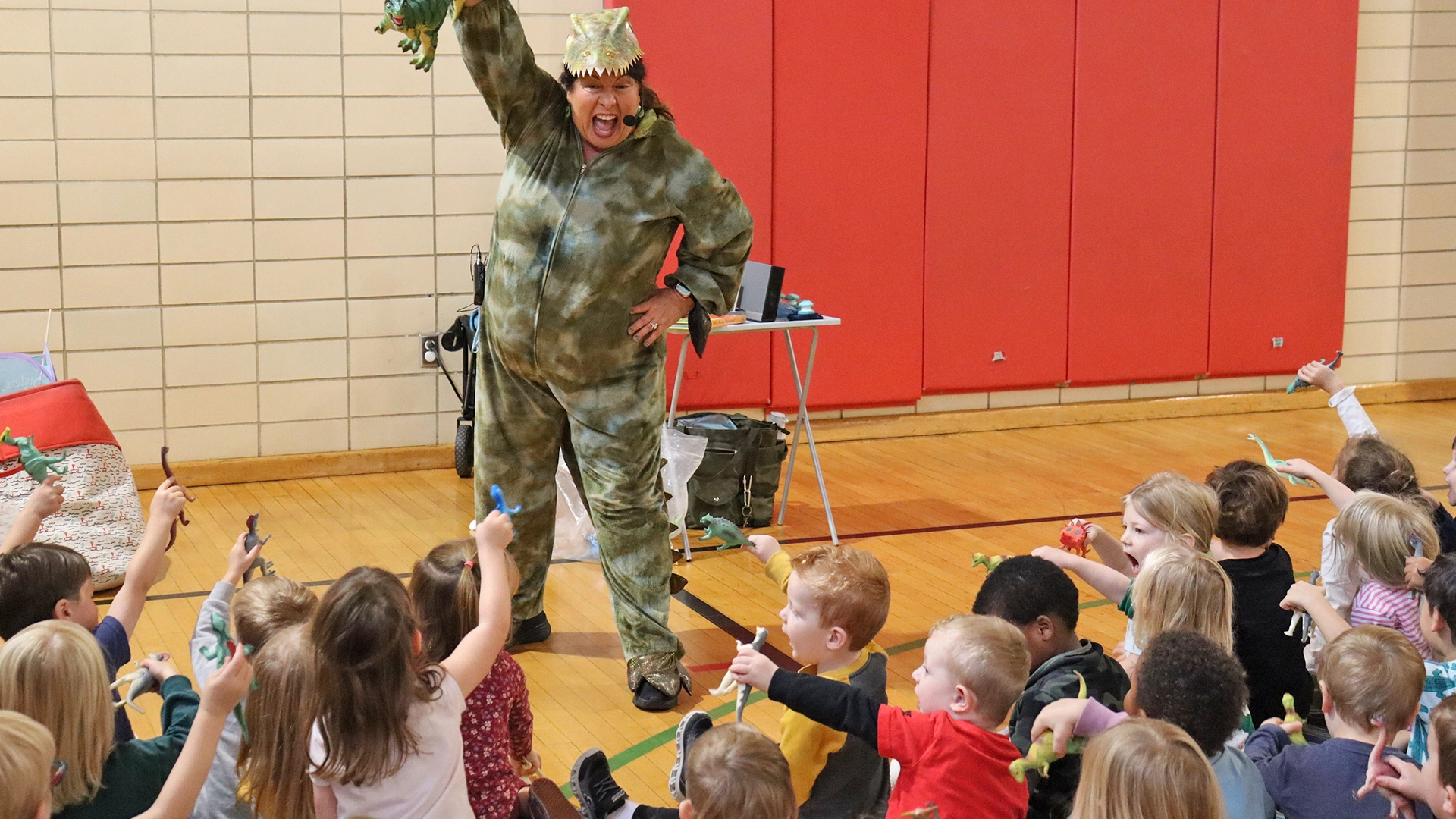 A teacher dressed in a costume entertaining children at Bright Beginnings Academy