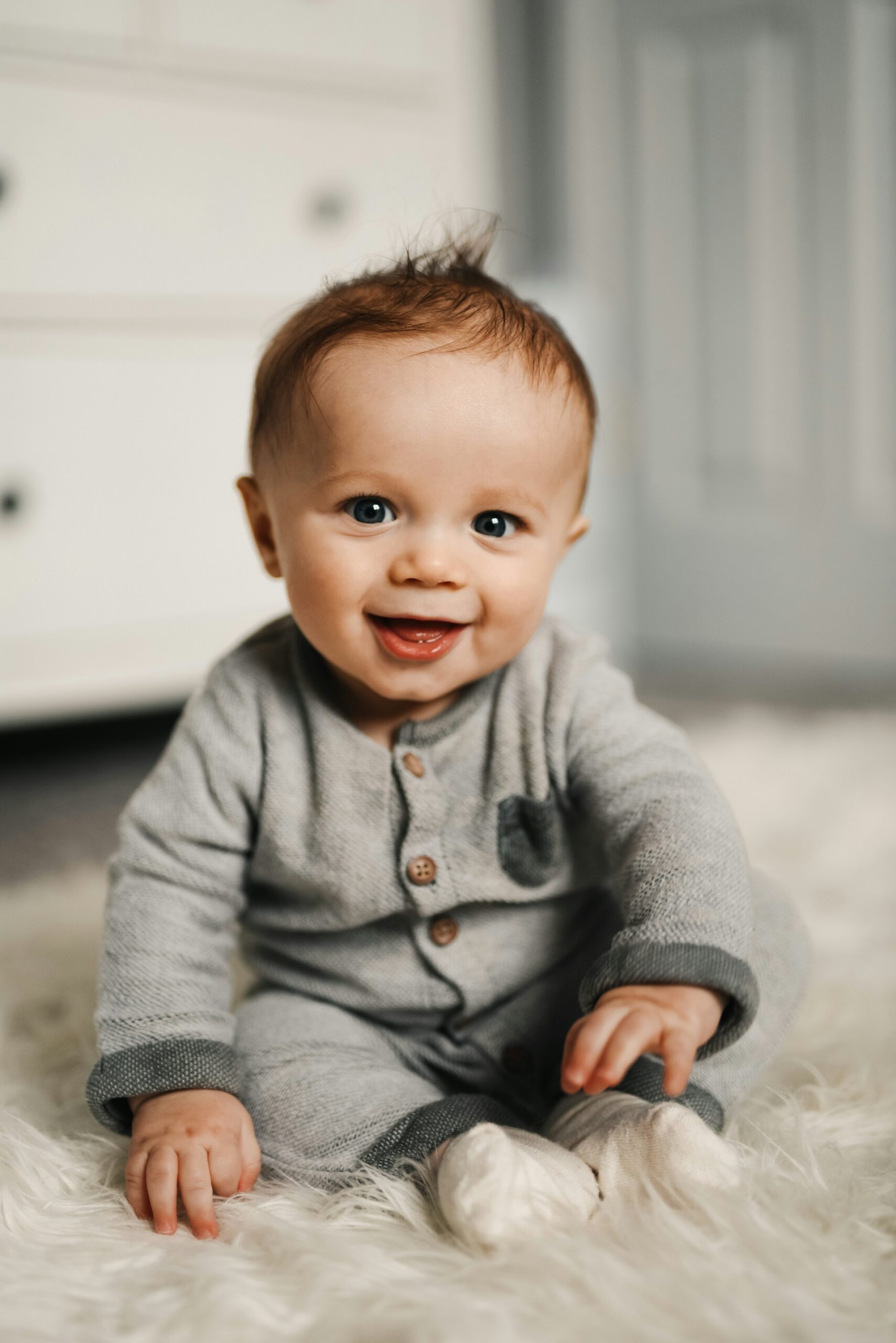 Happy baby in gray sweater
